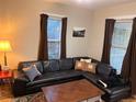 Living room featuring a sectional sofa and large windows at 2151 S Cherokee St, Denver, CO 80223