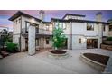 Home's backyard with stonework, landscaping, and a balcony at 11164 Beatrice Ct, Littleton, CO 80125