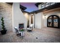 Brick paved patio with fireplace and comfortable seating area at 11164 Beatrice Ct, Littleton, CO 80125