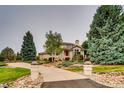 Two-story home with a landscaped yard and a long driveway at 8 Catamount Ln, Littleton, CO 80127