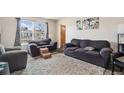 Bright living room featuring large windows and comfortable seating at 4545 Raritan St, Denver, CO 80211