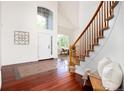 Two-story entryway with hardwood floors, curved staircase, and tile inlay at 10799 Eagle Crest Ct, Parker, CO 80138