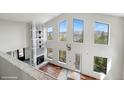 Open living room with vaulted ceilings and expansive windows at 1810 Saddleback Dr, Evergreen, CO 80439