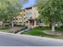Daytime view of apartment building exterior with landscaping at 350 S Clinton St # 7A, Denver, CO 80247