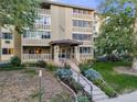 Daytime view of apartment building exterior with landscaping at 350 S Clinton St # 7A, Denver, CO 80247