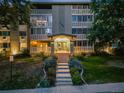 Night view of apartment building exterior with landscaping at 350 S Clinton St # 7A, Denver, CO 80247