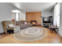 Cozy living room featuring a brick fireplace and hardwood floors at 902 Virginia St, Idaho Springs, CO 80452