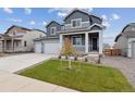 Two-story home with gray siding, three-car garage, and landscaped front yard at 5758 Ranch St, Mead, CO 80504