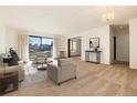 Spacious living area with lots of natural light and access to a balcony at 13961 E Marina Dr # 106, Aurora, CO 80014