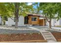 Modern craftsman style home with a carport and landscaped yard at 4643 S Cherokee St, Englewood, CO 80110