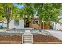 Modern craftsman style home with a carport and landscaped yard at 4643 S Cherokee St, Englewood, CO 80110