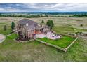 Aerial view of house with a large backyard and patio at 1820 S State Highway 83, Franktown, CO 80116