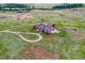 Aerial view of house on a large lot with a circular driveway at 1820 S State Highway 83, Franktown, CO 80116