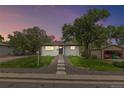 Charming ranch home with landscaped yard and detached garage at 7946 Joan Dr, Denver, CO 80221