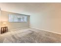 Spacious bedroom with neutral walls and carpet at 7695 E Quincy Ave # 102, Denver, CO 80237