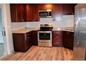 Modern kitchen featuring stainless steel appliances and granite countertops at 3038 S Xenia Ct, Denver, CO 80231