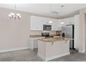 Modern kitchen featuring stainless steel appliances and granite countertops at 14321 E Tennessee Ave # 1-105, Aurora, CO 80012