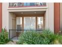 Private patio with a metal fence and lush greenery at 14321 E Tennessee Ave # 1-105, Aurora, CO 80012