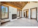 Main bedroom with fireplace, large windows and access to a private deck at 964 Alpensee Dr, Breckenridge, CO 80424