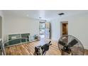 Unfinished basement with hardwood floors, new windows, and a fan at 13305 W 82Nd Ave, Arvada, CO 80005