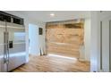 Kitchen with stainless steel refrigerator and unfinished area at 13305 W 82Nd Ave, Arvada, CO 80005