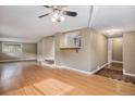 Open concept living room with hardwood floors and kitchen bar at 28532 Shadow Mountain Dr, Conifer, CO 80433