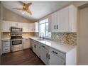 Galley kitchen with white cabinets, quartz countertops, and stainless steel appliances at 8465 Wheatgrass Cir, Parker, CO 80134