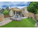Relaxing back patio with artificial turf, seating area, and privacy fence at 7193 S Versailles Way, Aurora, CO 80016