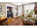 Living room with hardwood floors, fireplace and view into adjacent office at 34 W Maple Ave, Denver, CO 80223