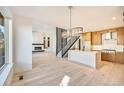 Modern kitchen with island, stainless steel appliances, and hardwood floors at 6920 E Lowry Blvd # F1P9, Denver, CO 80230