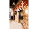 Building lobby with elevators and exposed brick walls at 1801 Wynkoop St # 205, Denver, CO 80202