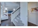 Elegant staircase leading to upper level; view of living room at 1165 Sugarloaf Ln, Erie, CO 80516