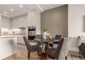 Kitchen features a dining area with round table and four gray chairs at 1901 Wazee St # 719, Denver, CO 80202