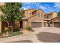 Townhouse exterior with two-car garage and landscaped entry at 9332 Sori Ln, Highlands Ranch, CO 80126