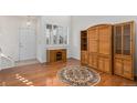 Living room with hardwood floors, built-in shelving, and a round rug at 24615 E Arizona Pl, Aurora, CO 80018