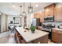 Modern kitchen with white countertops and wood cabinets at 1980 S Holly St # 2, Denver, CO 80222