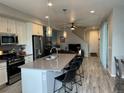 Open concept kitchen with island, stainless steel appliances, and grey countertops at 12261 Karls Ln, Northglenn, CO 80241