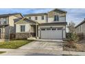Two-story home with a large garage and stone accents at 6645 Dry Fork Dr, Frederick, CO 80516