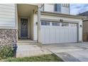 Front entrance with stone accents and a large gray door at 6645 Dry Fork Dr, Frederick, CO 80516
