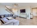 Spacious living room with a large sectional sofa and hardwood floors at 6645 Dry Fork Dr, Frederick, CO 80516