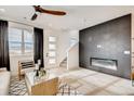 Bright living room featuring a modern fireplace and large windows at 356 N Geneva St, Aurora, CO 80010
