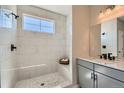 Clean bathroom with a walk-in shower and gray vanity at 356 N Geneva St, Aurora, CO 80010