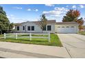 Ranch style home with attached garage and a well-maintained lawn at 5634 Clay St, Denver, CO 80221