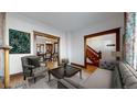 Living room with hardwood floors, fireplace, and views into dining room and staircase at 2225 N Ogden St, Denver, CO 80205