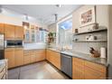 Modern kitchen with light wood cabinets, granite countertops, and stainless steel appliances at 1610 Little Raven St # 407, Denver, CO 80202