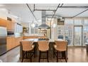 Modern kitchen with island, stainless steel appliances, and light wood cabinets at 1610 Little Raven St # 407, Denver, CO 80202