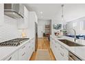 Modern white kitchen with gas cooktop and island at 1360 Yates St, Denver, CO 80204