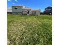 House back exterior showing a large grassy yard and wooden deck at 1415 S Pitkin Ct, Aurora, CO 80017