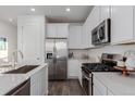 Modern kitchen with stainless steel appliances at 15881 Willow Way, Thornton, CO 80602