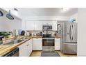 Modern kitchen with butcher block countertops and stainless steel appliances at 1242 S Crystal Way, Aurora, CO 80012